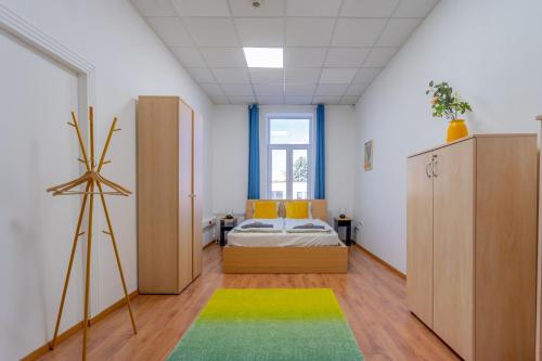 a bedroom with a bed and a large window at Grassalkovich Residence in Budapest