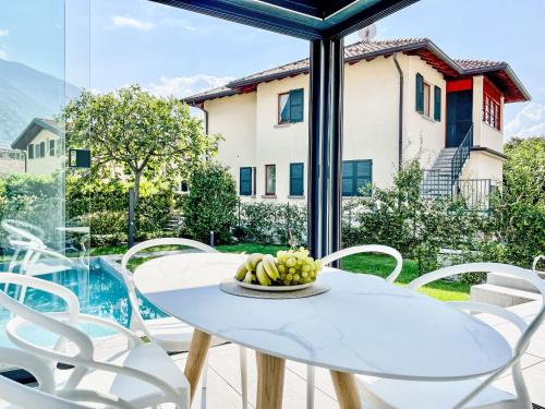 a white table and chairs in a room with a window at Holiday Home Allegra by Interhome in Dervio