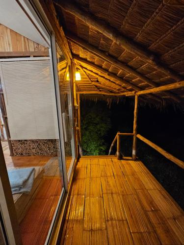 an empty porch of a house with a wooden floor at PANAKLUEA Cottage & Crafts - พนาเกลือ in Ban Kham