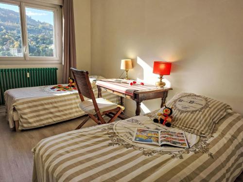 - une chambre avec 2 lits et un bureau avec une table dans l'établissement Apartment La côte du Parc-2 by Interhome, à Saint-Gervais-les-Bains