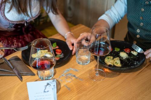 a group of people sitting at a table with wine glasses at Lanzenschuster in San Genesio Atesino