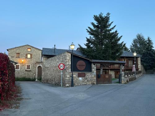 a stone building with a stop sign in front of it at Hotel Cal Rei de Talló in Bellver de Cerdanya 