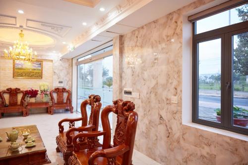 a dining room with a table and chairs and a window at Kiều Tiên Hotel in Long Thành