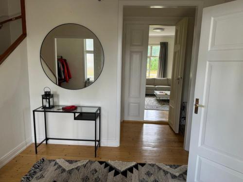 a hallway with a mirror and a table at Seegut Hovmantorp in Hovmantorp