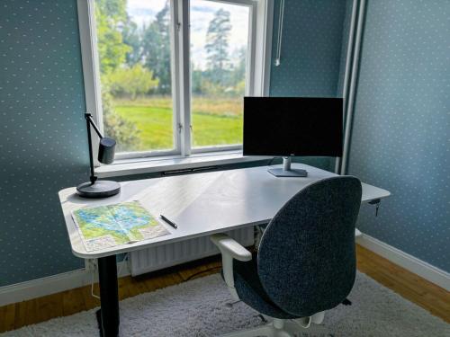 an office with a desk with a computer and a chair at Seegut Hovmantorp in Hovmantorp