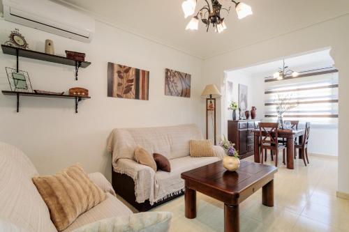 a living room with a couch and a table at Duplex En Gran Alacant in Puerto Marino