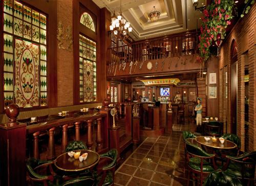 a bar with tables and chairs in a restaurant at Park Plaza Faridabad in Faridabad