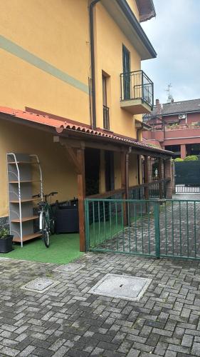 a house with a bike parked next to a fence at Milano Sud in Rogeredo