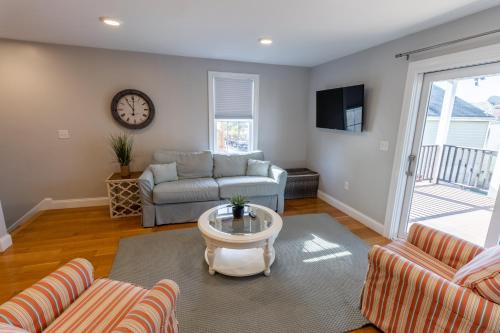 a living room with a couch and a table at The Newport Lofts - 617 Thames Street in Newport