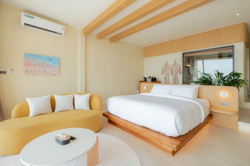 a bedroom with a bed and a couch at rocco villa in Ko Larn