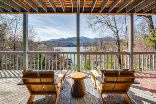a porch with two chairs and a view of a lake at Lakeside Serenity Mnt Views Decks Foosball in Lake Lure