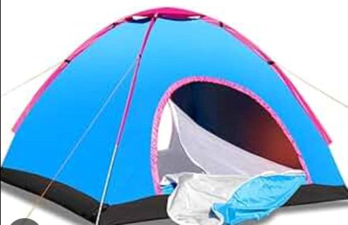 a blue tent with its door open on a white background at Murali Guesthouse Hampi in Hampi