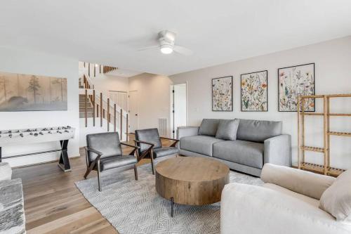 a living room with a couch and a table at Lakeside Serenity Mnt Views Decks Foosball in Lake Lure