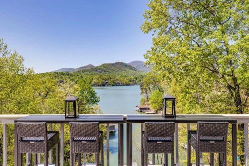 a deck with chairs and a view of a lake at Lakeside Serenity Mnt Views Decks Foosball in Lake Lure