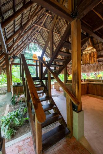 a wooden staircase in a building with a roof at Canto Tayrona Ecolodges in Buritaca