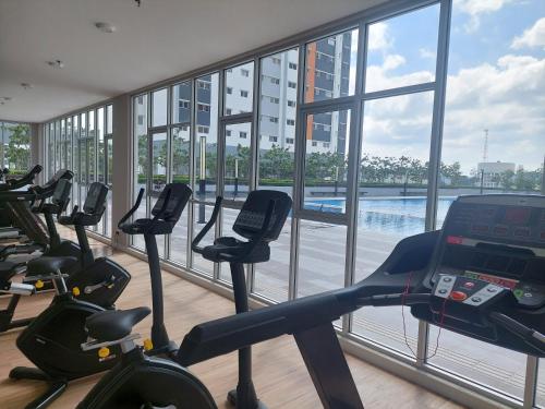 a gym with treadmills and exercise bikes in a building at KLIA Travel Homestay - 3R 2B - WIFI & NETFLIX in Sepang