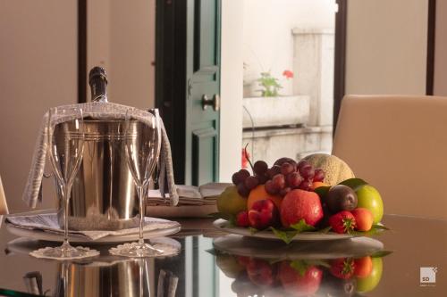 a bowl of fruit on a table with a blender at Aldrovandi Residence City Suites in Rome