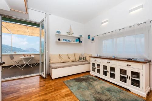 a living room with a couch and a table at CefalHome - KEFAHELION in SantʼAmbrogio