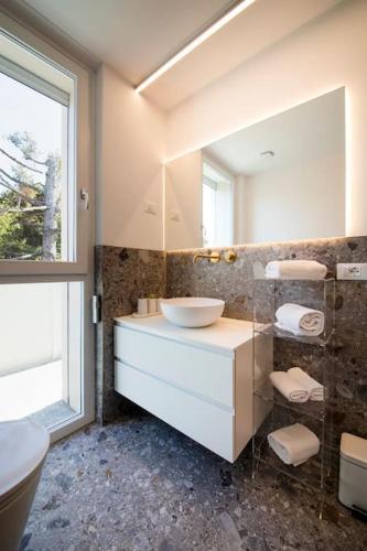 a bathroom with a sink and a mirror at Luxury House - Small Heated Pool in Bardolino