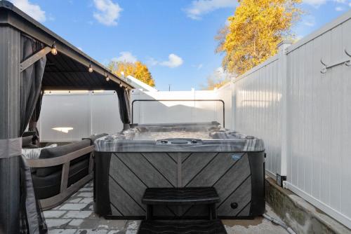a bath tub sitting next to a white fence at Imperial Porch Haven Cozy Fire Pit Fenced Yard in Imperial