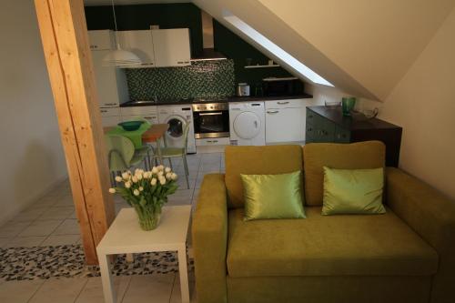 a living room with a couch and a table with flowers at Köln-Kerpen Boutique-Ferienwohnungen Angela & Maurizio in Kerpen