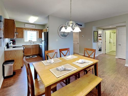a kitchen and dining room with a table and chairs at Paradise Pines Whispering Pines 133 in Pigeon Forge