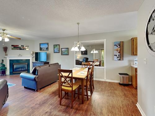 a dining room and living room with a table and chairs at Paradise Pines Whispering Pines 133 in Pigeon Forge