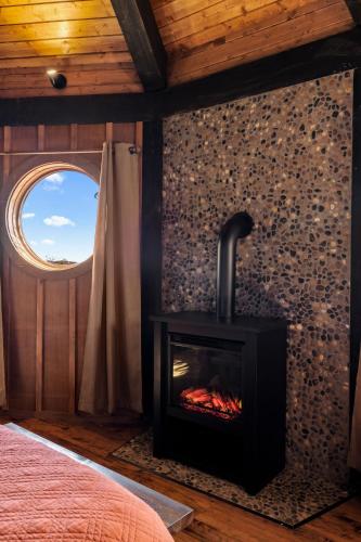 a fireplace in a room with a window at Ancient Lore Village in Knoxville