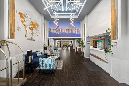a lobby with a large mural on the wall at Clarion Pointe Lakeland I-4 in Lakeland