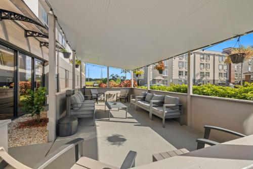 an outdoor patio with tables and chairs and windows at Clarion Pointe Lakeland I-4 in Lakeland