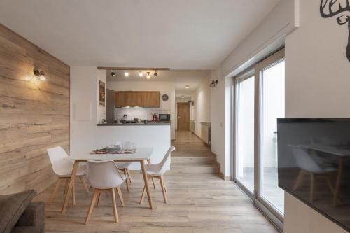 eine Küche und ein Esszimmer mit Tisch und Stühlen in der Unterkunft Anni - AffittiPontediLegno in Temù