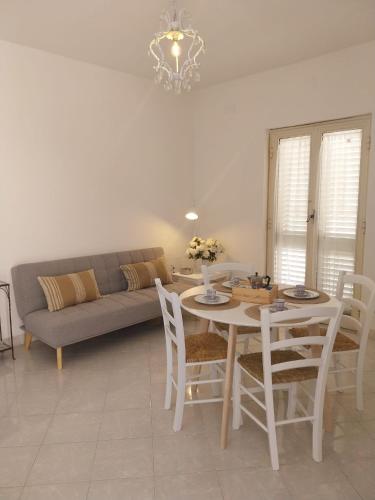 a living room with a table and a couch at Casa Sisina in Capri