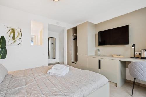 a white bedroom with a bed and a desk at Comfort & Style in Vibrant Luxembourg Coliving in Luxembourg