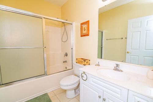 a bathroom with a toilet and a shower and a sink at Lakefront and 1 Block to Beach! Walk to Main St in Myrtle Beach