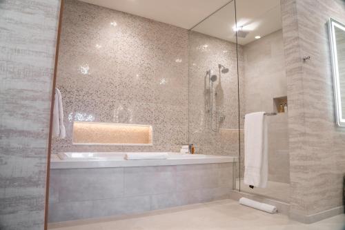 a bathroom with a tub and a sink and a shower at Garden of the Gods Resort & Club in Colorado Springs