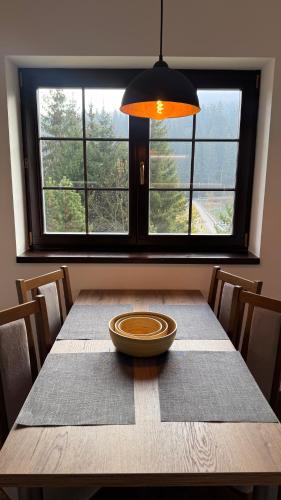 a dining room table with a bowl on top of it at Vila Olívia - Apartmán Olívia 2 in Ružomberok