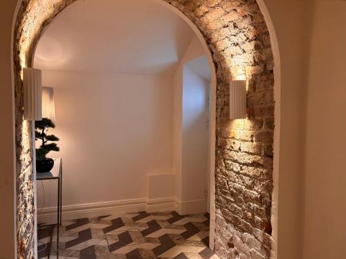 an archway in a room with a stone wall at Luxurious 2 bedroom apartment with sea view in Monkstown in Blackrock
