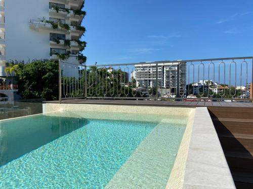 a swimming pool on the roof of a building at Francisca Luxury Suites - Adults Only in Puerto Vallarta
