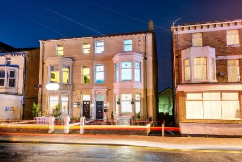 a building on a city street at night at Velvet Coaster Apartments in Blackpool