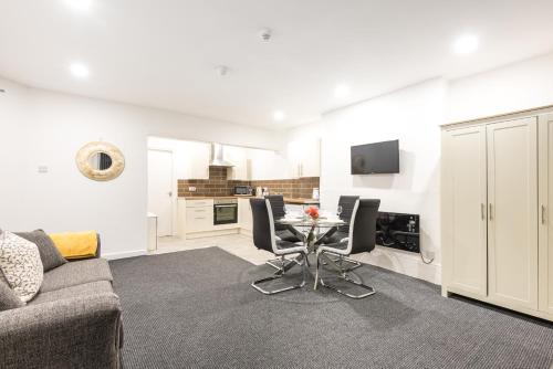 a living room with a couch and a table at Velvet Coaster Apartments in Blackpool