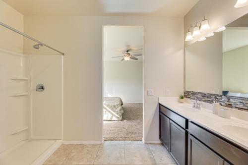a bathroom with a shower and a sink and a mirror at Family-Friendly Home with Playroom in San Tan Valley in San Tan Valley