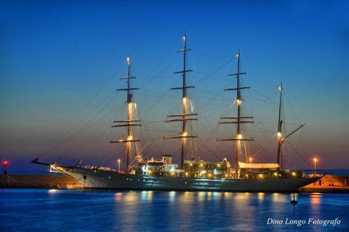 a large ship sitting in the water at night at Vianova Affittacamere in Giurdignano