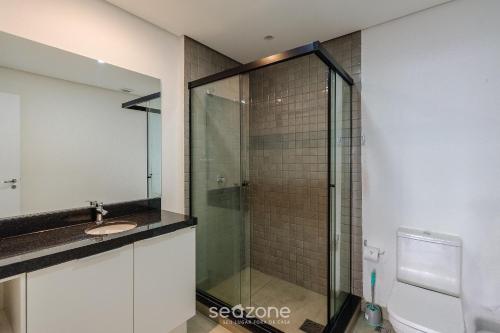 a bathroom with a glass shower and a sink at TCO - Apartamentos no Centro Histórico Porto Alegre/RS in Porto Alegre