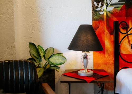 a lamp on a table next to a bed at Ilocos Urban Wave Resort in Laoag
