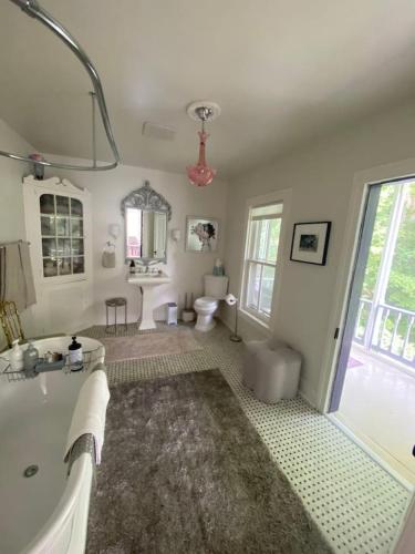 a bathroom with a tub and a sink and a toilet at Trouvaille House Sweet Suite in Harpers Ferry