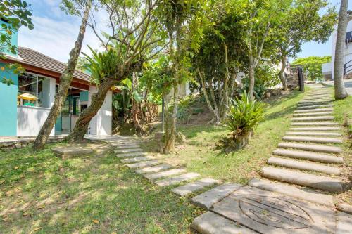 a set of stone steps leading up to a house at Pousada do Arvoredo in Bombinhas