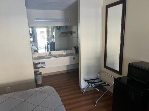 a bathroom with a sink and a mirror at FairBridge Inn Express Tukwila in Tukwila