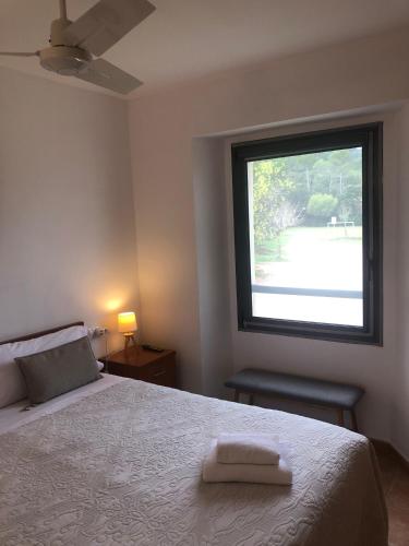 a bedroom with a large bed with a window at Hostal la Salut de Terrades in Terrades