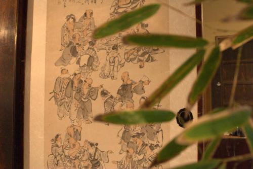 a drawing of people on a wall at 出雲一棟貸し 時代の宿 宮野屋 江戸時代の古民家 in Taisha
