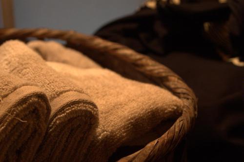 a close up of a blanket on a bed at 出雲一棟貸し 時代の宿 宮野屋 江戸時代の古民家 in Taisha